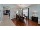 Well-lit dining room featuring hardwood floors, stylish furnishings, and a window with views of the outdoors at 16843 Cedar Run Dr, Orlando, FL 32828