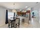Open kitchen with modern stainless steel appliances, breakfast bar, and ample counter space for cooking at 16843 Cedar Run Dr, Orlando, FL 32828