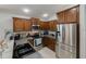 Well-equipped kitchen features stainless steel appliances, dark cabinetry, and sleek countertops at 16843 Cedar Run Dr, Orlando, FL 32828