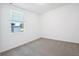 Bedroom with carpeted floors and a window for natural light at 4709 Jasmine Cir, Leesburg, FL 34748