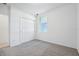 Carpeted bedroom featuring closet and a window for ample light at 4709 Jasmine Cir, Leesburg, FL 34748