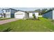 Well-kept single-story home with a green lawn, brick driveway, and manicured landscaping at 4709 Jasmine Cir, Leesburg, FL 34748