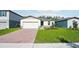 Charming single-story home featuring a brick driveway, well-maintained lawn, and neutral-colored exterior at 4709 Jasmine Cir, Leesburg, FL 34748