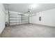 Spacious two-car garage with a large metal door and ample room for storage at 4709 Jasmine Cir, Leesburg, FL 34748