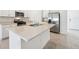Bright kitchen island featuring a stainless sink, white cabinets and stainless appliances at 4709 Jasmine Cir, Leesburg, FL 34748