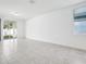 Spacious living room featuring tile flooring, natural light, and sliding glass door access to the outdoors at 4709 Jasmine Cir, Leesburg, FL 34748