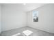 An empty, light-filled room with tile flooring, white walls, and a view from the window at 4709 Jasmine Cir, Leesburg, FL 34748