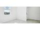 Bright, airy room with light-colored tile flooring, white walls, and ample natural light at 4709 Jasmine Cir, Leesburg, FL 34748