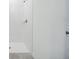 White tiled shower with modern fixtures in a clean and bright bathroom at 4709 Jasmine Cir, Leesburg, FL 34748