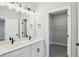 Modern bathroom featuring double sinks, white cabinetry, and a walk-in closet at 5133 Passion Flower Way, Winter Garden, FL 34787