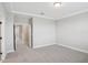 Neutral bedroom with plush carpet, ceiling trim detail, and multiple doors at 5133 Passion Flower Way, Winter Garden, FL 34787