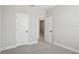 View of a bedroom with gray carpet, gray walls, white doors and trim at 5133 Passion Flower Way, Winter Garden, FL 34787
