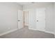 Well-lit bedroom with plush carpet and multiple doors providing access at 5133 Passion Flower Way, Winter Garden, FL 34787