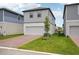 Charming two-story home featuring a two-car garage, manicured lawn, and simple landscaping at 5133 Passion Flower Way, Winter Garden, FL 34787