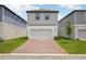 This is a charming two-story home featuring a two-car garage and brick paver driveway at 5133 Passion Flower Way, Winter Garden, FL 34787