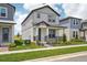 Two-story home featuring light gray exterior, covered porch and manicured lawn in a well-maintained neighborhood at 5133 Passion Flower Way, Winter Garden, FL 34787