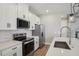 Close-up of the kitchen showcasing stainless steel appliances and a subway tile backsplash at 5133 Passion Flower Way, Winter Garden, FL 34787