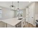 Spacious kitchen island with sink, stainless steel dishwasher and stylish pendant lights at 5133 Passion Flower Way, Winter Garden, FL 34787