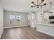 Open-concept living space featuring wood-look floors, a kitchen with a modern island, and natural light at 5133 Passion Flower Way, Winter Garden, FL 34787