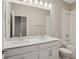 Bright bathroom with double sink vanity, modern fixtures, and shower over tub at 5139 Passion Flower Way, Winter Garden, FL 34787
