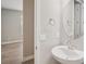 A half bath with a round mirror and stylish fixtures, offering convenience and modern aesthetics at 5139 Passion Flower Way, Winter Garden, FL 34787