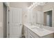 Bathroom featuring a double sink vanity with white cabinets and light countertops at 5139 Passion Flower Way, Winter Garden, FL 34787