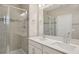 A bright bathroom with a double vanity and a glass-enclosed shower at 5139 Passion Flower Way, Winter Garden, FL 34787
