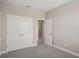 Bedroom features a double door closet, neutral colors, and carpet at 5139 Passion Flower Way, Winter Garden, FL 34787