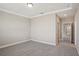 A bedroom showcases a neutral color palette, carpet, and an open door at 5139 Passion Flower Way, Winter Garden, FL 34787