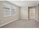 Serene bedroom with two large windows allowing natural light, complemented by neutral carpet and walls at 5139 Passion Flower Way, Winter Garden, FL 34787