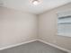 Neutral bedroom with a window that lets in natural light and gray carpet at 5139 Passion Flower Way, Winter Garden, FL 34787