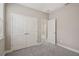 Bedroom with gray carpet, double door closet, and neutral wall paint at 5139 Passion Flower Way, Winter Garden, FL 34787