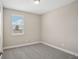A tidy bedroom is filled with neutral colors and natural light from the single window at 5139 Passion Flower Way, Winter Garden, FL 34787