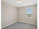 A cozy bedroom features carpet, neutral paint, and a street view from the window at 5139 Passion Flower Way, Winter Garden, FL 34787