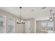 Bright dining area with a modern chandelier and natural light from surrounding windows at 5139 Passion Flower Way, Winter Garden, FL 34787