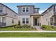 Charming two-story home featuring a beautifully landscaped yard and inviting front porch at 5139 Passion Flower Way, Winter Garden, FL 34787