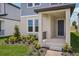 Inviting front porch with columns, manicured landscaping, and a stylish entry door at 5139 Passion Flower Way, Winter Garden, FL 34787