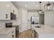 Bright kitchen features white cabinetry, stainless steel appliances, and a modern island with quartz countertops at 5139 Passion Flower Way, Winter Garden, FL 34787