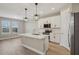 Modern kitchen with white cabinets, a center island, stainless steel appliances, and stylish pendant lighting at 5139 Passion Flower Way, Winter Garden, FL 34787