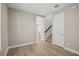 Cozy living room showing doorway to kitchen and stairs with wood laminate flooring and natural light at 5139 Passion Flower Way, Winter Garden, FL 34787
