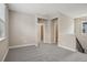 Spacious loft with neutral carpet and walls, featuring doorways to other rooms at 5139 Passion Flower Way, Winter Garden, FL 34787