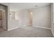 Spacious loft with neutral carpet and walls, featuring doorways to other rooms at 5139 Passion Flower Way, Winter Garden, FL 34787