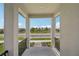 Covered porch with decorative railings, offering views of the neighborhood and sunny skies at 5139 Passion Flower Way, Winter Garden, FL 34787