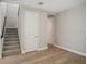 Carpeted staircase with a black handrail and natural light provides access to the upper level at 5139 Passion Flower Way, Winter Garden, FL 34787