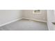 A bright carpeted bedroom offers a window view and base trim at 5217 Passion Flower Way, Winter Garden, FL 34787