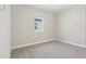 A spare bedroom with a window, neutral walls, and carpet at 5217 Passion Flower Way, Winter Garden, FL 34787