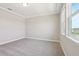 Light-filled bedroom with carpet, a tray ceiling and bright windows at 5217 Passion Flower Way, Winter Garden, FL 34787