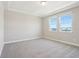 Bright bedroom with carpet, two windows and neutral walls at 5217 Passion Flower Way, Winter Garden, FL 34787
