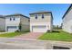 Charming two-story home featuring a pristine white garage door, manicured lawn, and a welcoming brick driveway at 5217 Passion Flower Way, Winter Garden, FL 34787