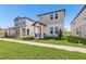View of the property's exterior showcasing its modern design and neighboring houses at 5217 Passion Flower Way, Winter Garden, FL 34787